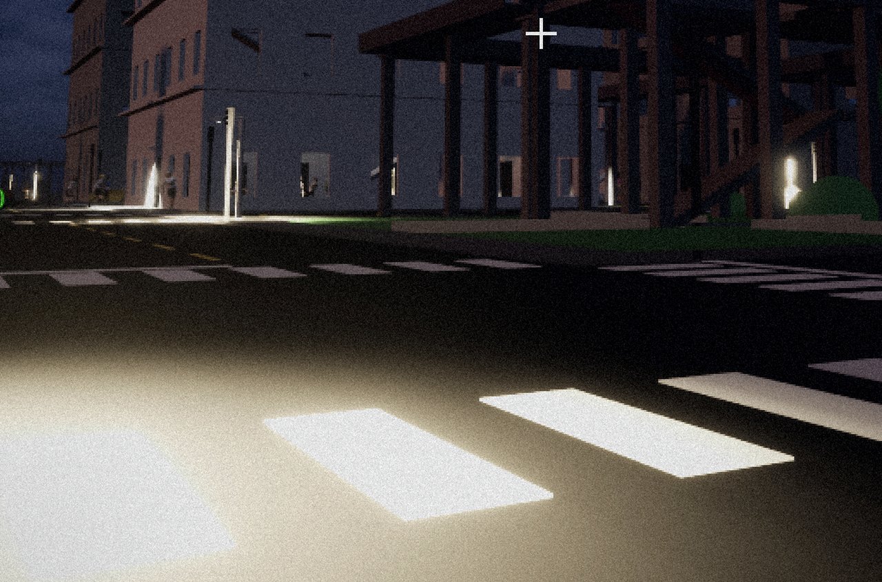 An empty city street at dawn, pools of light falling across the road.